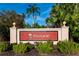 Welcome to The Pinnacle, where the entrance sign is surrounded by lush tropical landscaping at 5156 Pinnacle Dr, Oldsmar, FL 34677
