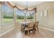 Bright dining nook featuring a rustic dining table, elegant drapery, and a large window with view at 5156 Pinnacle Dr, Oldsmar, FL 34677