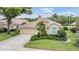 Charming single-story home featuring a tile roof, meticulously manicured landscaping, and a two-car garage at 5156 Pinnacle Dr, Oldsmar, FL 34677