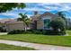 Charming single-story home with a lush lawn, mature landscaping, and a neutral-toned exterior at 5156 Pinnacle Dr, Oldsmar, FL 34677