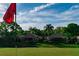 Beautiful view of the golf course, showcasing two homes nestled amongst trees, and blue skies at 5156 Pinnacle Dr, Oldsmar, FL 34677