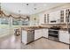 Bright kitchen featuring stainless steel appliances, granite countertops, and an adjacent breakfast nook at 5156 Pinnacle Dr, Oldsmar, FL 34677