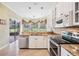 Bright kitchen featuring stainless steel appliances, granite countertops, and sliding doors to the outside patio at 5156 Pinnacle Dr, Oldsmar, FL 34677