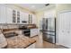 Well-lit kitchen featuring white cabinets, stainless steel appliances, and granite countertops at 5156 Pinnacle Dr, Oldsmar, FL 34677