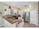 Well-lit kitchen featuring white cabinets, stainless steel appliances, granite countertops and eat in bar at 5156 Pinnacle Dr, Oldsmar, FL 34677