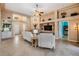 Open-concept living room features a fireplace, ceiling fan, and views to the front door at 5156 Pinnacle Dr, Oldsmar, FL 34677