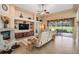 The bright living room showcases a fireplace, TV, and large sliding glass doors to the outdoors at 5156 Pinnacle Dr, Oldsmar, FL 34677