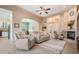 Bright living room with neutral tones features a fireplace, ceiling fan, and views to other rooms at 5156 Pinnacle Dr, Oldsmar, FL 34677