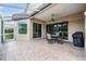 Screened patio with tile flooring, ceiling fan, and outdoor seating area at 5156 Pinnacle Dr, Oldsmar, FL 34677