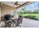 Covered patio with ceiling fan, table and chairs, and a view of lush golf course at 5156 Pinnacle Dr, Oldsmar, FL 34677