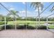 Screened lanai featuring view of the golf course and surrounding natural landscape at 5156 Pinnacle Dr, Oldsmar, FL 34677