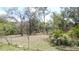 Large backyard with mature trees, backing up to a wooded area at 5287 Azalea Cir, Dade City, FL 33523