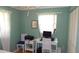 Bedroom featuring a white desk, chair, computer, and white curtains and light green walls at 5287 Azalea Cir, Dade City, FL 33523
