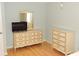 Bedroom showcasing hardwood floors and dressers at 5287 Azalea Cir, Dade City, FL 33523