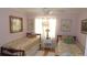 Cozy bedroom with twin beds, floral bedding, sheer curtains, ceiling fan and wooden furniture at 5287 Azalea Cir, Dade City, FL 33523