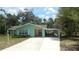 Ranch-style home boasts a welcoming porch, spacious driveway, and charming curb appeal at 5287 Azalea Cir, Dade City, FL 33523