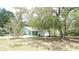 The home's exterior features a quaint design, complemented by a well-manicured lawn at 5287 Azalea Cir, Dade City, FL 33523