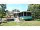 Charming home featuring a screened porch and deck, perfect for outdoor enjoyment at 5287 Azalea Cir, Dade City, FL 33523