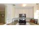 Bright kitchen featuring stainless steel appliances, white cabinets, and modern lighting fixtures at 5287 Azalea Cir, Dade City, FL 33523