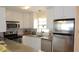 Modern kitchen with stainless steel appliances, granite countertops, and bright natural light at 5287 Azalea Cir, Dade City, FL 33523