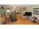 Spacious living area with hardwood floors, fireplace, and a view into the dining area and kitchen at 5287 Azalea Cir, Dade City, FL 33523