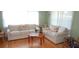 Cozy living room with comfortable white sofas, hardwood floors, and natural light at 5287 Azalea Cir, Dade City, FL 33523