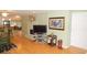 Open living area featuring a brick fireplace, hardwood floors, and a view into the kitchen at 5287 Azalea Cir, Dade City, FL 33523