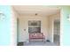 Cozy covered porch with seating, textured walls, and vintage-style lighting at 5287 Azalea Cir, Dade City, FL 33523