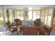 Inviting sun room with wicker furniture, tile floors, and large windows at 5287 Azalea Cir, Dade City, FL 33523