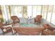 Bright sunroom with wicker furniture, tile flooring, and large windows offering plenty of natural light at 5287 Azalea Cir, Dade City, FL 33523