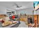 Cluttered bedroom with a bed, large window, ceiling fan, and exposed drywall at 5713 Shore S Blvd, Gulfport, FL 33707
