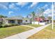 A quaint house with lush front yard, and sidewalk views, next to other businesses at 5713 Shore S Blvd, Gulfport, FL 33707