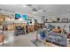Eclectic living area with a white brick fireplace, TV, musical instruments, and open kitchen at 5713 Shore S Blvd, Gulfport, FL 33707