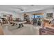 Spacious living room featuring a pool table, large window, and comfortable seating area at 5713 Shore S Blvd, Gulfport, FL 33707