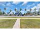 Scenic street view showcasing lush green spaces and distant water views near parking spots at 5713 Shore S Blvd, Gulfport, FL 33707