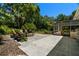 An expansive patio with multiple seating areas surrounded by lush landscaping at 60 Lakeview Ct, Palm Harbor, FL 34683