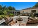 An expansive patio with an outdoor kitchen and dining surrounded by lush landscaping at 60 Lakeview Ct, Palm Harbor, FL 34683