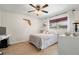 Cozy bedroom with a ceiling fan, wood floors, and a decorative map of Florida on the wall at 60 Lakeview Ct, Palm Harbor, FL 34683