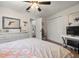 This is a bedroom with a ceiling fan, dresser with mirror, and a closet with louvered doors at 60 Lakeview Ct, Palm Harbor, FL 34683