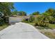 Charming single-story home featuring a well-manicured lawn and driveway leading to a two-car garage at 60 Lakeview Ct, Palm Harbor, FL 34683