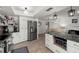 Modern kitchen featuring stainless steel appliances, white cabinetry, and granite countertops at 60 Lakeview Ct, Palm Harbor, FL 34683