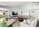 Comfortable living room with vaulted ceilings, built-in shelving, and a large television for entertainment at 60 Lakeview Ct, Palm Harbor, FL 34683