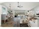 Spacious living room and dining area with slate floors, stylish furnishings, and views of the screened-in pool at 60 Lakeview Ct, Palm Harbor, FL 34683
