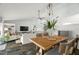 Open concept living and dining area with stylish furnishings and a partial view of the kitchen at 60 Lakeview Ct, Palm Harbor, FL 34683