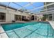 A screened pool featuring clear water with a lounge area and bar just outside the house at 60 Lakeview Ct, Palm Harbor, FL 34683