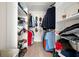Walk-in closet with built-in shelving and rods for ample storage, offering organized space for clothing and accessories at 60 Lakeview Ct, Palm Harbor, FL 34683