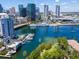 Breathtaking aerial view showcasing the waterfront property, marina, and scenic city skyline with blue skies and scattered clouds at 612 Arbor Lake Ln, Tampa, FL 33602