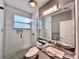 Updated bathroom featuring a sleek glass-enclosed shower and granite countertops at 612 Arbor Lake Ln, Tampa, FL 33602
