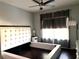 Inviting bedroom featuring an elegant tufted headboard and hardwood floors, offering a serene retreat at 612 Arbor Lake Ln, Tampa, FL 33602