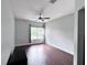 Bright bedroom with wood floors, a large window with peaceful views, and a modern ceiling fan at 612 Arbor Lake Ln, Tampa, FL 33602
